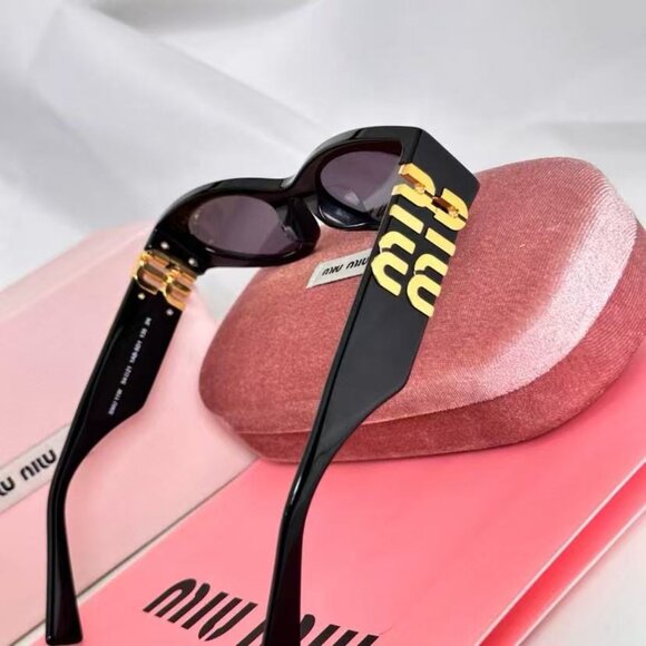 Miu Miu black sunglasses featuring elegant gold accents main image 5